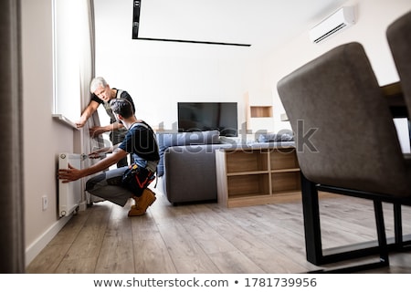 Сток-фото: Male Plumber Repairing Thermostat