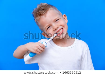 Foto stock: Dentist With Toothbrush And Kid Patient At Clinic