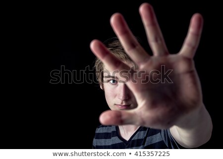 Foto d'archivio: Image Of A Boy With His Hand Extended Signaling To Stop