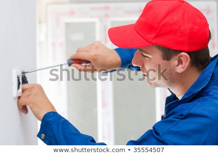 A Young Electrician Installing An Electrical Switch In A New House Foto d'archivio © Lighthunter