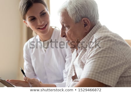 Stock photo: Old Female Psychiatrist Visiting Young Male Patient