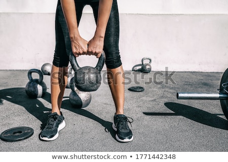 Stock photo: Closeup Of Hands Lifting A Heavy Kettlebell