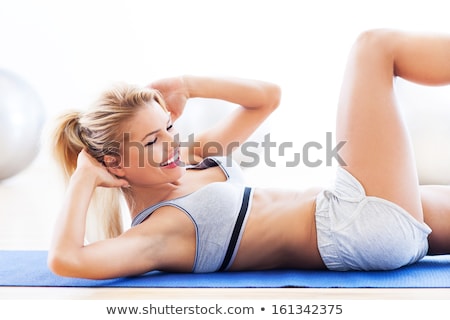 ストックフォト: Woman Doing Sit Ups On Gym Ball