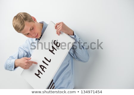 Stock photo: Handsome Businessman Showing Contact Me Text On A Billboard