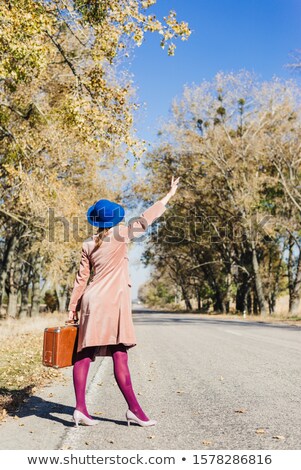 Stock photo: Woman Walking Along The Road