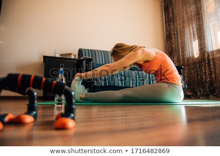 Stockfoto: Beautiful Young Woman Doing Stretching Exercises During Yoga