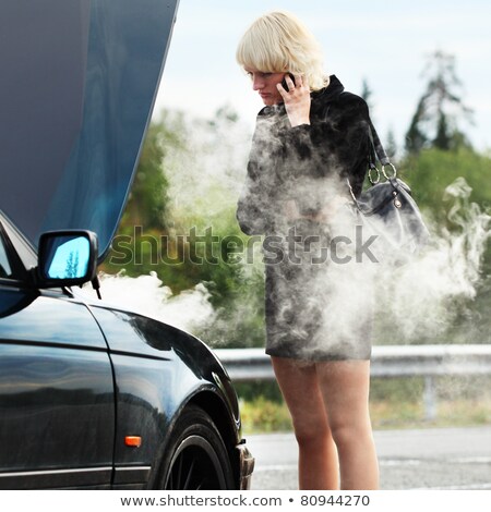 Stock fotó: Woman Standing And Smoking On Car Parking