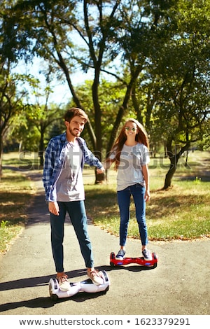 Stock photo: Young Couple Riding Hoverboard