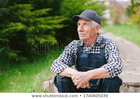 Stockfoto: Mature Man Resting On Shovel