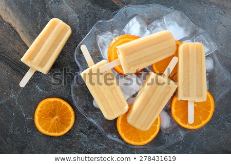 Zdjęcia stock: Fruit Ice Cream On Stick With Slices Fruits On Black Slate