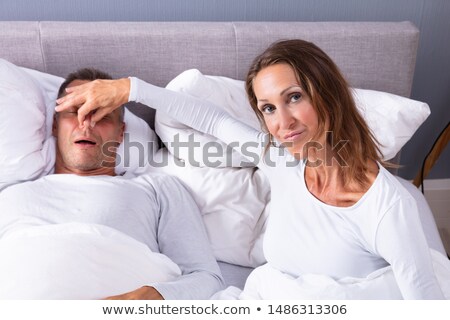 Foto stock: Woman Holding Her Husbands Nose To Stop Him From Snoring