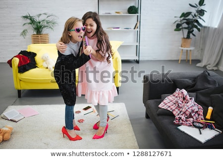 Foto stock: Teenage Girls Singing To Hairbrush And Having Fun