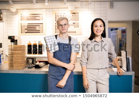 ストックフォト: Two Young Best Waiters Of Luxurious Restaurant Or Cafe Meeting New Guests