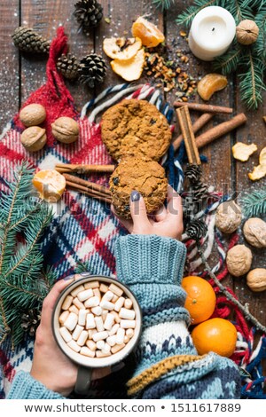 Foto stock: Young Female Hand Taking Cookie While Having Hot Coffee With Marshmallows