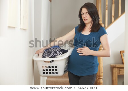 [[stock_photo]]: Stressed Pregnant Woman Doing Chores At Home