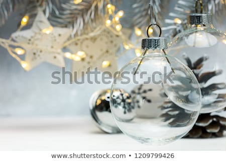 Stok fotoğraf: Hanging Ornaments On Blurred Silver Background