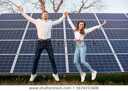 Foto d'archivio: Young Couple Wearing White With A Blue Sky Background