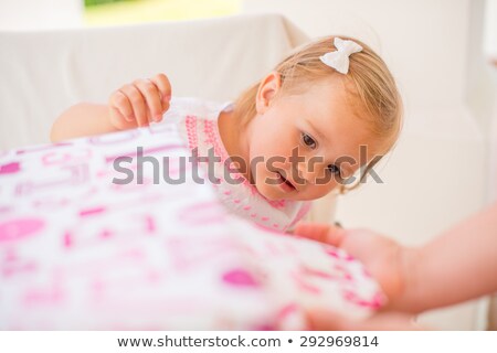 Stock photo: Excited Cutie Unwrapping Her Birthday Present