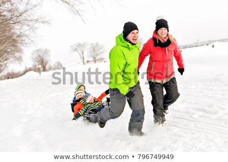 Сток-фото: Mother And Father Pulling Sledges With Children