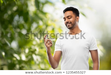 Stok fotoğraf: Indian Man With Perfume Over Natural Background