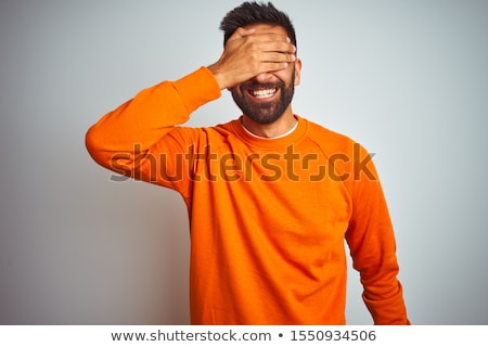 Foto stock: Portrait Of Young Indian Man Over Dark