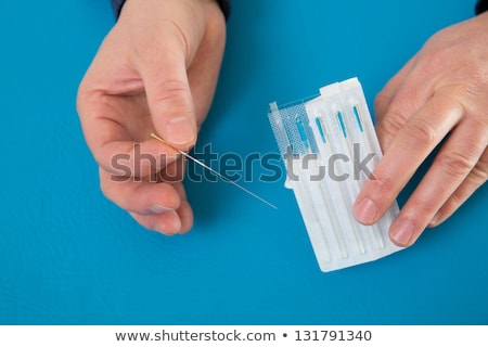 Stok fotoğraf: Acupuncture Needles Set And Blister On Blue