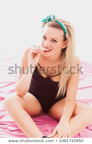 Stok fotoğraf: Lovely Woman In Bodysuit Posing With Candy