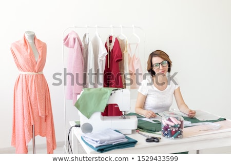 Stock photo: Young Pretty Woman Fashion Designer Sitting At Her Work Desk