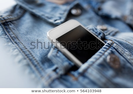 Foto d'archivio: Smartphone In Pocket Of Denim Jacket Or Waistcoat