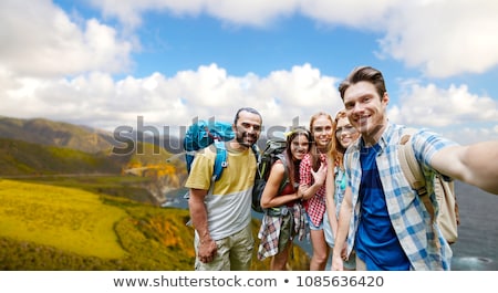 Foto d'archivio: Smiling Woman With Backpack On Big Sur Hills