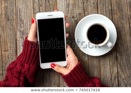 Stock photo: Fashionable Girl Holding Smart Phone In Hand And Showing At Camera