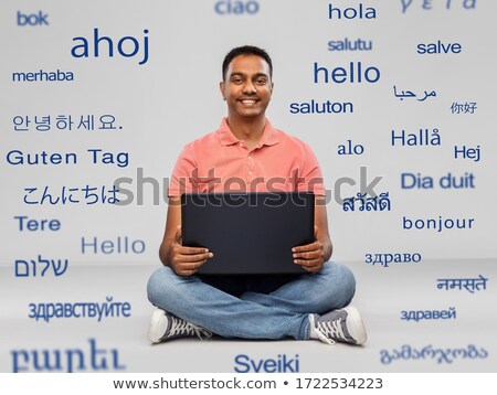 Stock fotó: Man With Computer Over Words In Foreign Languages