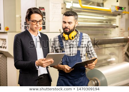 Two Young Engineers Testing New System Of Quality Control In Chemical Factory 商業照片 © Pressmaster