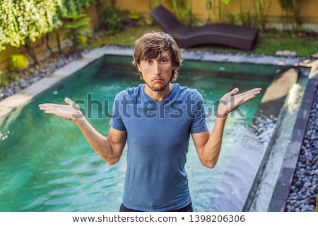 Сток-фото: Man Chooses Chemicals For The Pool Swimming Pool Service And Equipment With Chemical Cleaning Produ