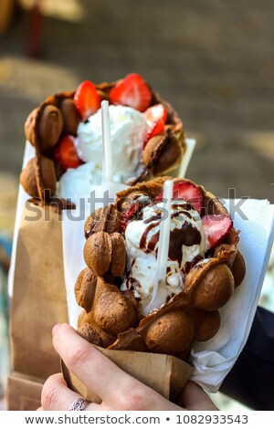 Zdjęcia stock: Bubble Waffles With Ice Cream In Woman Hand Close Up Street Food Decorative