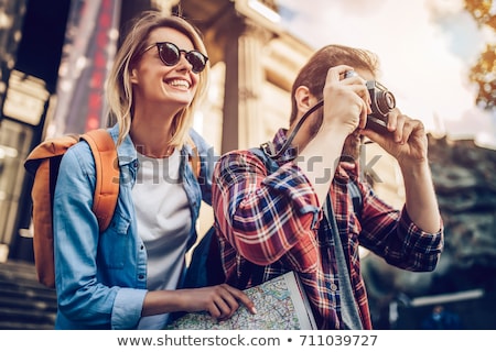 ストックフォト: Happy Couple Of Tourists With City Guide And Map