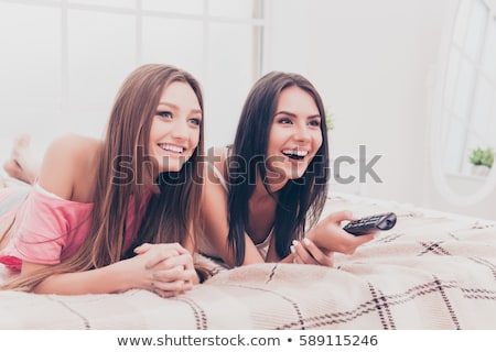 Foto d'archivio: Young Woman Is Watching An Interesting Film On Tv