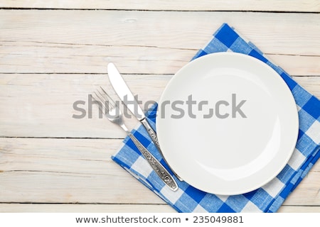 Foto stock: Empty Plate And Silverware Over Wooden Table