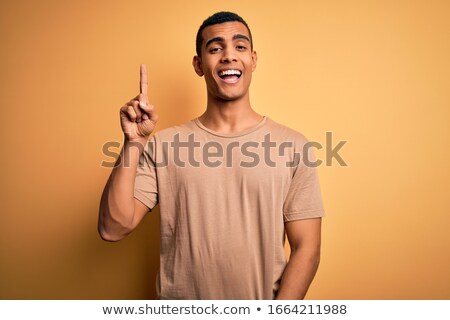 Zdjęcia stock: Happy Afro Amercan Man Pointing Finger Up