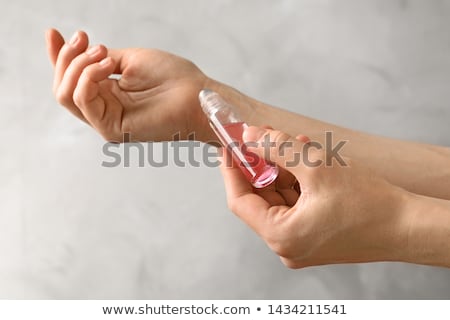 Foto d'archivio: Young Woman With Bottle Of Perfume