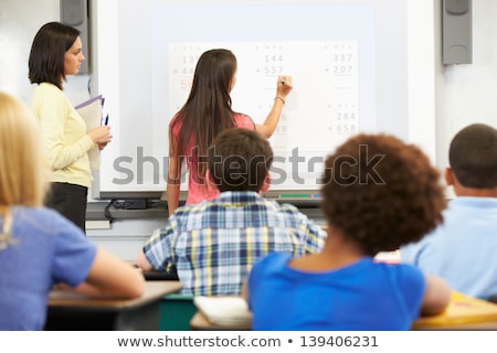 Zdjęcia stock: Female Student Writing On Classroom Whiteboard