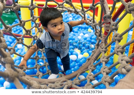 Stockfoto: Happy Toddler Plays Indoor In A Tunnel