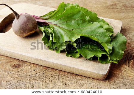 Foto stock: Chard With Leaves And Beetroots On Soup On Wooden Board