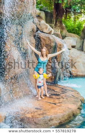 ストックフォト: Mother And Son Relaxing Under A Waterfall In Aquapark