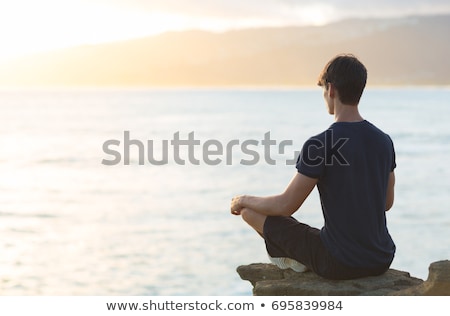 Stock fotó: Young Prayer On The Coast Of Background Sunrise