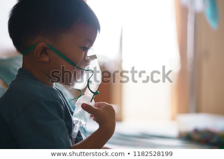 Foto d'archivio: Young Boy Using Nebulizer For Asthma And Respiratory Diseases At Home Teenager Doing Inhalation Inh