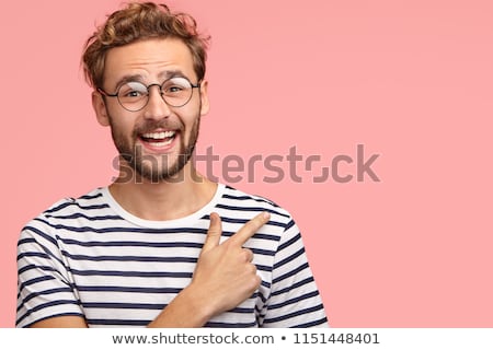 Foto stock: Horizontal Shot Of Attractive Male With Joyful Expression Being Focused Into Distance Has Stubble