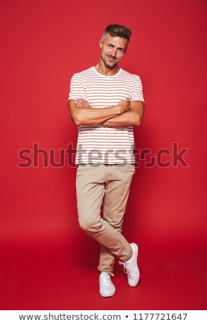 Сток-фото: Full Length Photo Of Optimistic Man In Striped T Shirt Smiling A