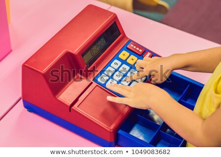 Stockfoto: The Boy Plays With The Childrens Cash Register