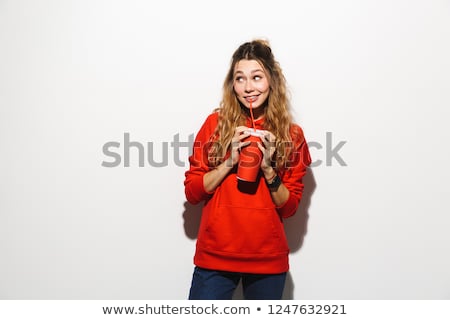 Stockfoto: Image Of Optimistic Woman 20s Wearing Red Sweatshirt Drinking So